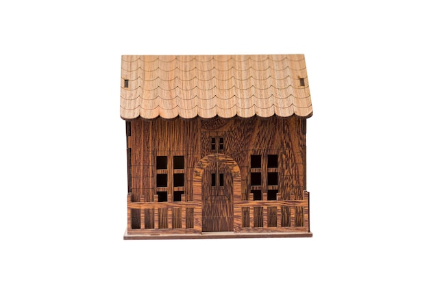 Maison miniature en bois isolée sur fond blanc pour les concepts de l'immobilier et de la construction