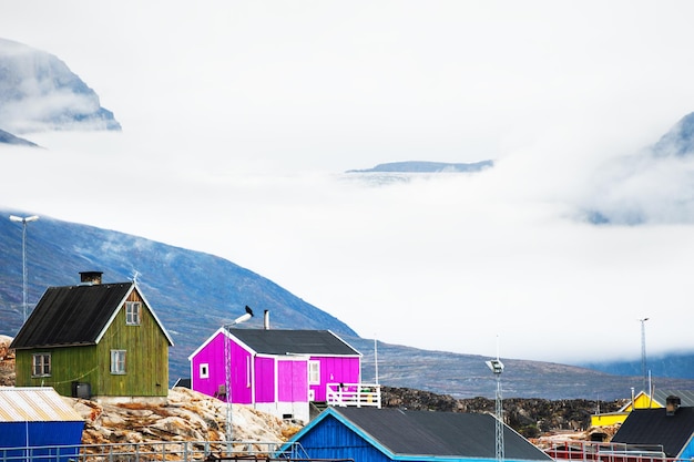 Maisons colorées sur les falaises contre les montagnes du village de Saqqaq, dans l'ouest du Groenland.