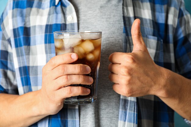 Mâle main tenant un verre de cola, gros plan