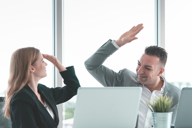 Male patron Salut cinq à la travailleuse pour le succès