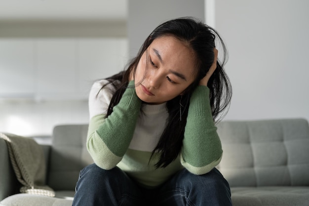 Malheureuse jeune femme asiatique déprimée se sentant triste et seule après une rupture ou un divorce