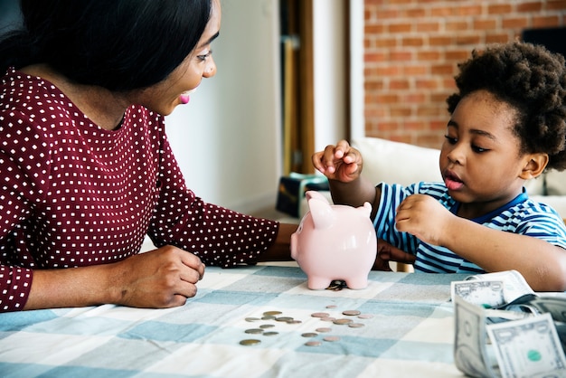 Photo maman et fils économiser de l'argent à la tirelire