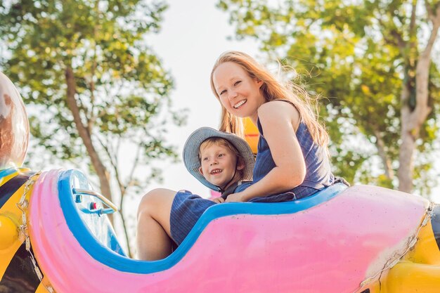 Maman et son fils s'amusent dans un parc d'attractions.