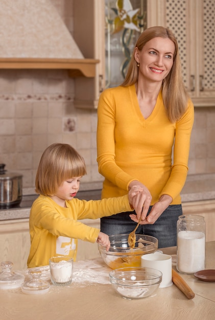 Photo maman et son petit enfant cuisinent dans la cuisine.