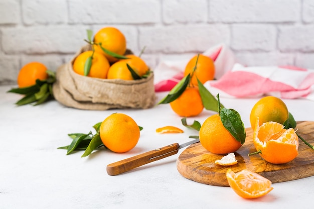 Mandarines mandarines orange fraîches avec des feuilles vertes sur une table