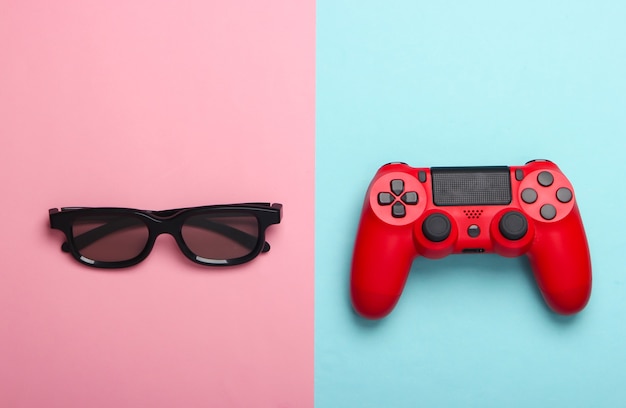 Manette de jeu, lunettes 3d sur pastel bleu rose.