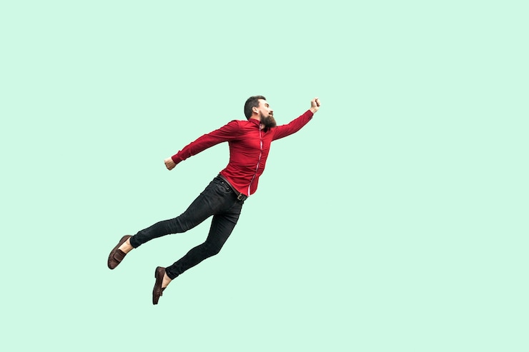 Photo a la manière de superman. notion d'enthousiasme. homme d'affaires barbu fort se sentait un super-héros et s'envolait. studio intérieur tourné isolé sur fond vert clair.