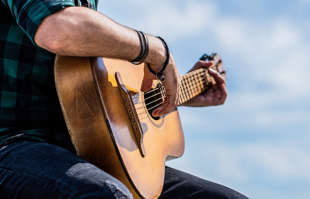 Mans mains jouant de la guitare acoustique, gros plan. Jeu de guitares acoustiques