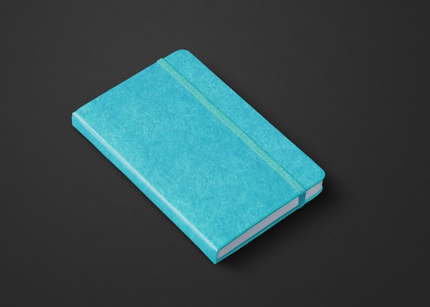 Maquette de cahier fermé bleu aqua isolée sur fond noir