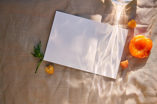 Maquette de carte de papeterie saisonnière d'été minimaliste avec des ombres dures et des fruits et des baies jaunes Conception d'invitation de carte postale de recette de menu à plat avec espace de copie avec la lumière du soleil