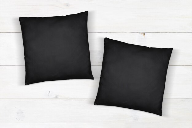 Maquette de coussin noir sur bois blanc