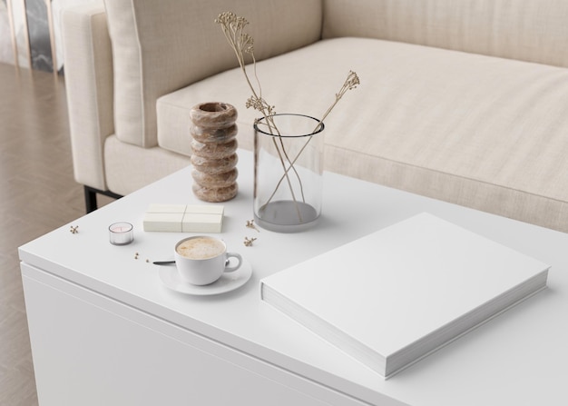 Maquette de couverture de livre blanc avec vase de tasse à café et autres accessoires de maison sur table blanche Modèle vierge pour votre conception Présentation de couverture de livre ou de catalogue rendu 3D