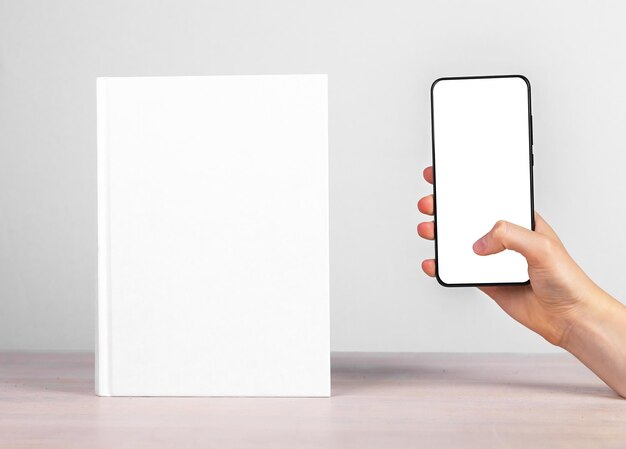 Maquette de téléphone portable et maquette de livre papier Concept de lecture en ligne et hors ligne Annonce de littérature