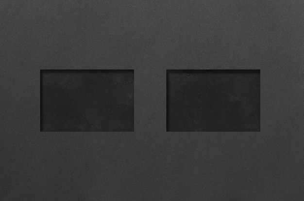 Maquettes rectangulaires noires sur fond de béton foncé éléments de conception ou portefeuille espace de copie