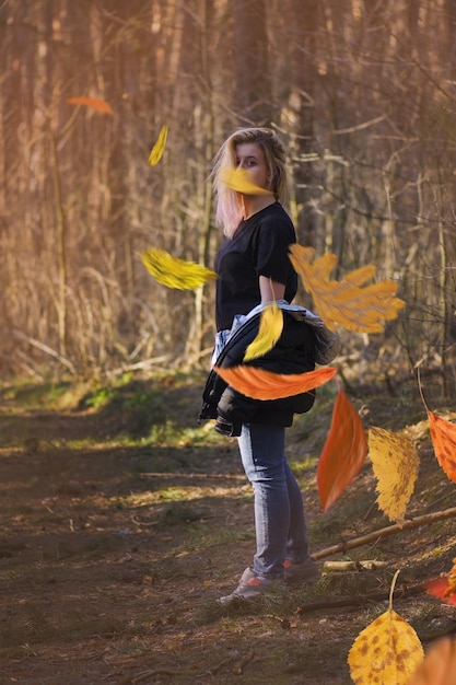 Marcher dans le parc d'automne Belle jeune femme marchant dans la forêt d'automne