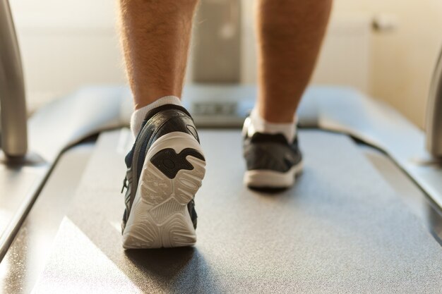 Marcher sur tapis roulant. Close-up of man walking par tapis roulant dans un club de sport