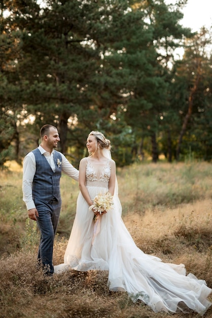 Le marié et la mariée se promènent dans la forêt