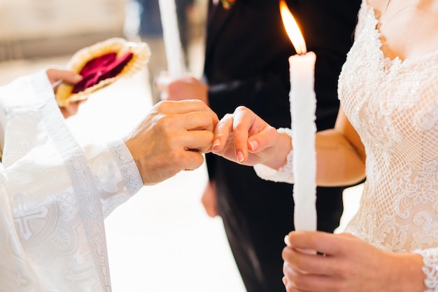 La mariée et le marié à l'église devant le vœu du prêtre et l'ex