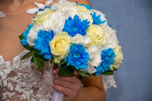 Une mariée merveilleuse tient un bouquet de mariage dans ses mains pendant la cérémonie de mariage.