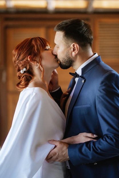 Mariée en robe blanche avec un bouquet et le marié en costume bleu