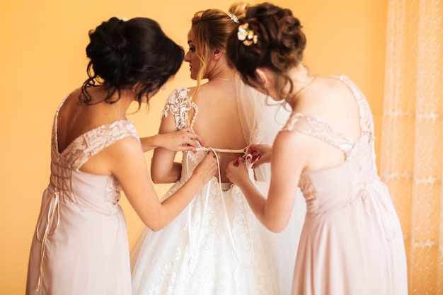 Mariée en robe blanche posant pendant la préparation de la cérémonie de mariage