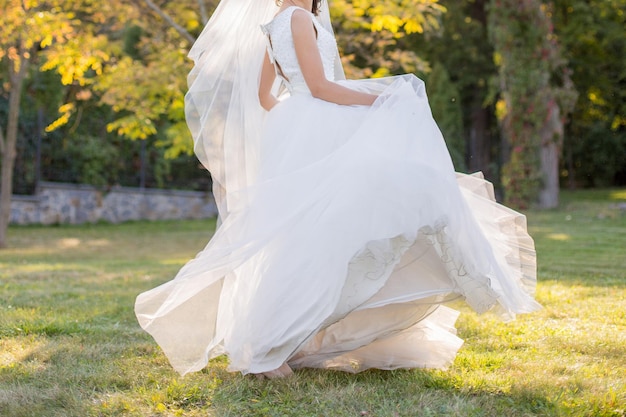 La mariée seule dans le pré sous le soleil