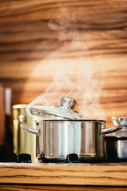 Marmite en métal à la vapeur dans le bois de la cuisine