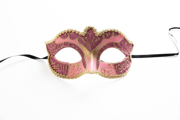 Photo masque de carnaval orné de couleur rose isolé sur fond blanc