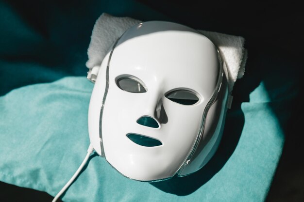 Photo le masque led pour le rajeunissement du visage brille dans différentes couleurs