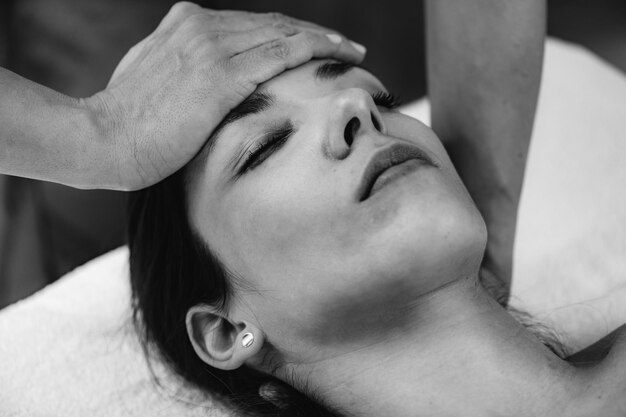 Photo massage craniosacral par un thérapeute cst massant la tête d'une femme