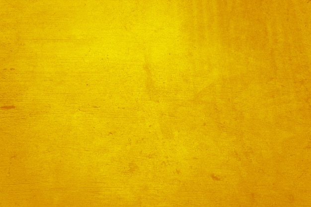 Photo matériau de béton ou de ciment jaune dans la texture du mur abstrait.