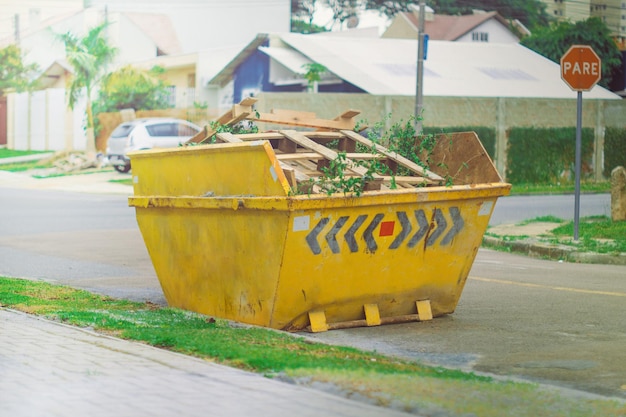 matériau de construction benne à ordures jaune sur la voie publique dans le quartier