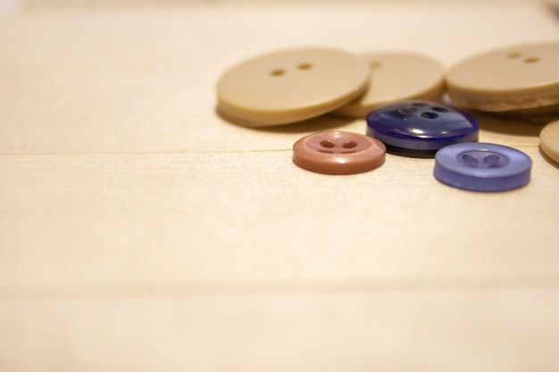 Matériaux pour travaux d'aiguille. Boutons et aiguilles sur une table en bois. Le concept de passe-temps, de couture et de ne