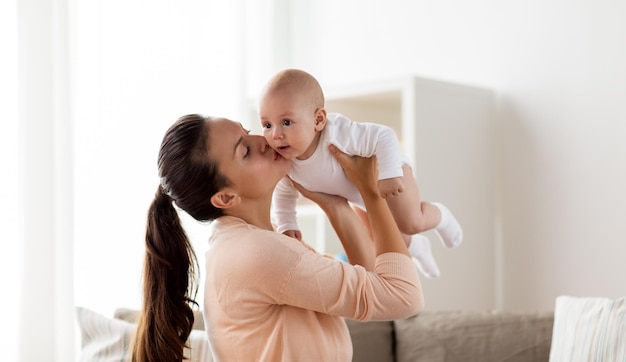 la maternité et les gens concept de famille mère heureuse embrassant petit bébé garçon à la maison