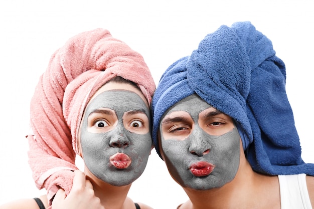 mec avec une femme envoie un baiser aérien, masque pour la peau, fabrique un masque pour la peau ensemble, drôle de couple d'amoureux, rôle de genre émotionnel photo isolé