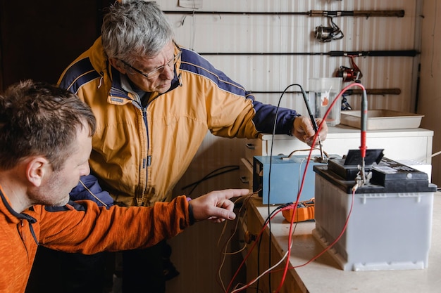 Mécanicien faisant le service sur la batterie de voiture électrique