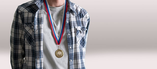 Une médaille d'or sur la poitrine humaine réalise le succès