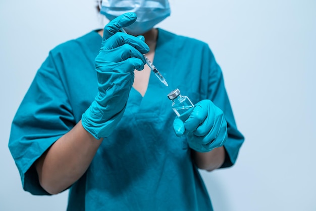 Médecin asiatique avec seringue et vaccin pour protéger le virus covid19 sur fond blanc