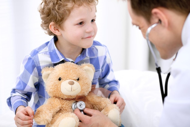 Médecin examinant un enfant patient par stéthoscope