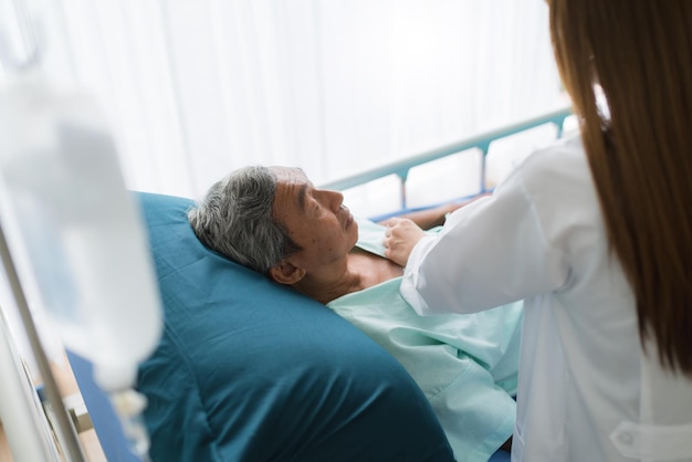 Une médecin examinant un patient âgé à l'hôpital
