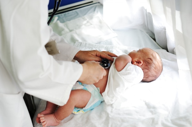 Médecin avec nouveau-né sur un fond blanc