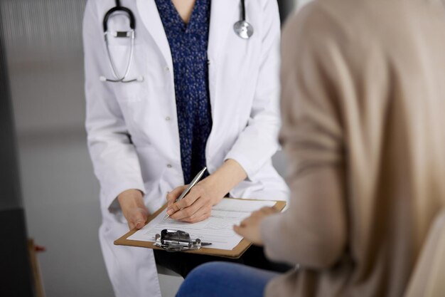 Médecin et patient discutant de l'examen de santé actuel alors qu'ils étaient assis à la clinique. Service médical parfait à l'hôpital. Notion de médecine.