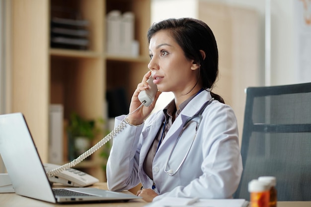 Médecin répondant à un appel téléphonique