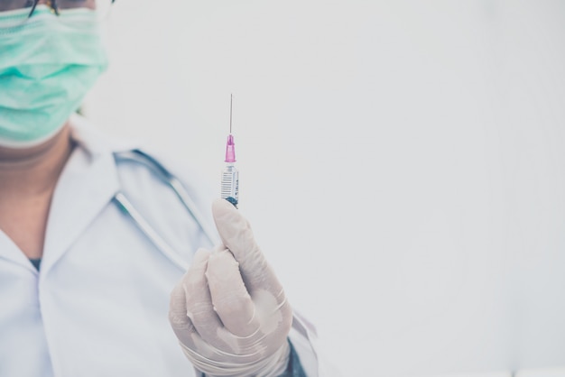 Médecin avec une seringue prête pour l'injection de vaccin au patient.