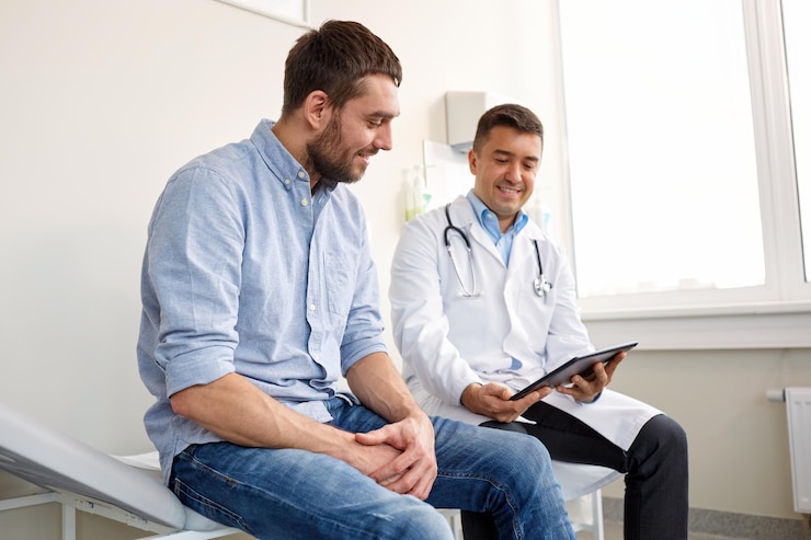 Photo médecine soins de santé et concept de personnes médecin souriant avec tablette ordinateur et jeune homme patient réunion à l'hôpital