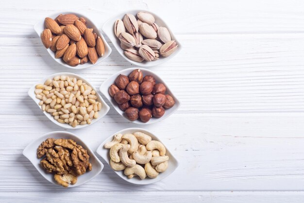 Mélange de noix Pistaches amandes noix pignons de pin noisettes et noix de cajou Snack dans un bol backgrond