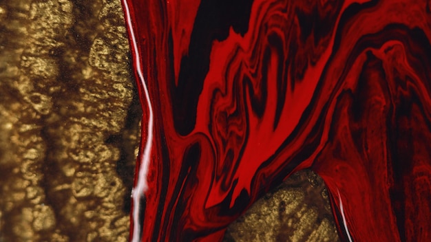 Photo un mélange de pigments de fond abstraits en rouge et en or noir