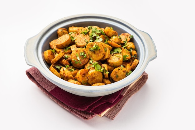 Mélanger les racines de taro frites Arbi ki sabji ghuiya masala curry Sabzi ou arvi dum Masala garni avec de la coriandre