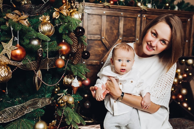 Mère avec deux enfants à arbre de noël