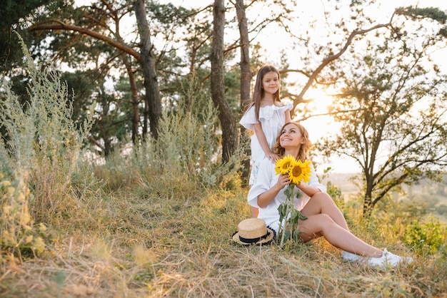 Mère élégante et belle fille s'amusant sur la nature